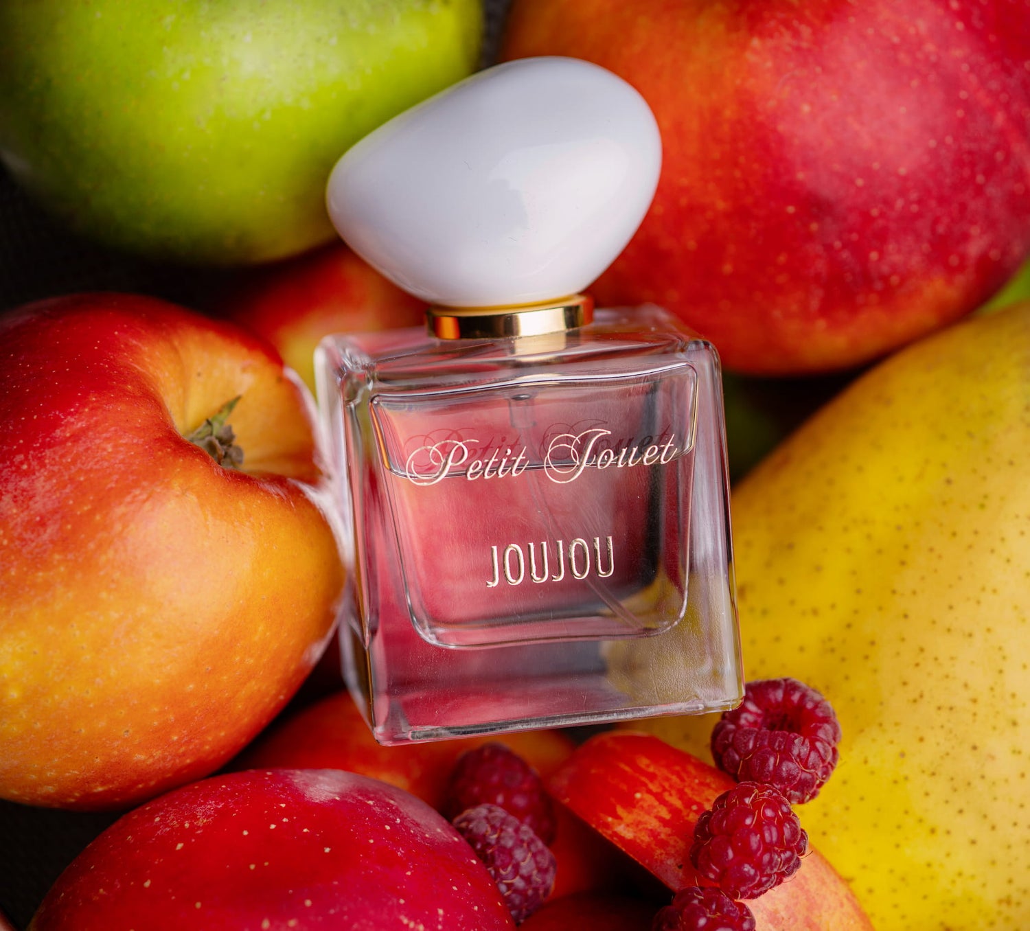 Petit Jouet JouJou perfume bottle on a fruit background